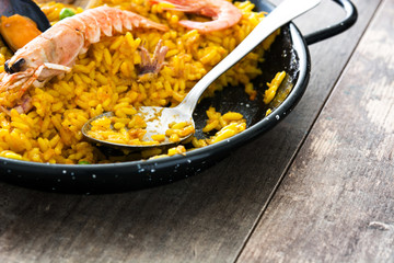 Traditional spanish seafood paella on wooden background.Top view
