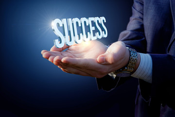 Success word in businessman hands.