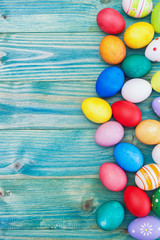 Colorful Easter eggs on a blue wooden background