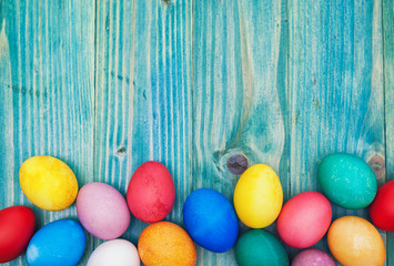 Colorful Easter eggs on a blue wooden background