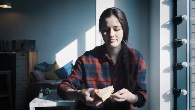 Young women eating hamburger or Sandwich in restaurant