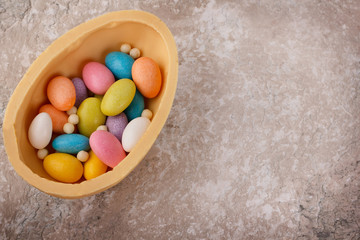 Chocolate egg for Easter on wooden background