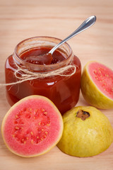 Brazilian dessert goiabada - jam of guava with fresh goiaba on wooden background. Selective focus