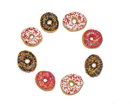 Circle of sprinkles  donuts isolated on white background, top view