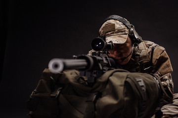 military contracto with his sniper rifle at night. war, army, weapon, technology and people concept - obrazy, fototapety, plakaty