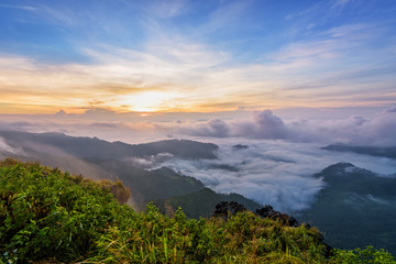 Naklejka na ściany i meble Beautiful landscape nature, sunrise on peak mountain with sun cloud fog and bright colors of sky in winter at Phu Chi Fa Forest Park is a famous tourist attraction of Chiang Rai Province, Thailand