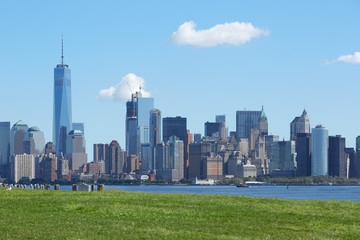 New York city skyline and green grass in a clear sunny day 