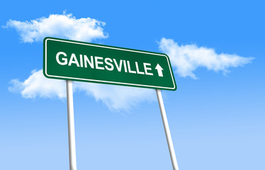 Road sign - Gainesville. Green road sign (signpost) on blue sky background. (3D-Illustration)
