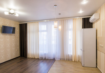 The interior of a small room with kitchen, renovated, unfurnished
