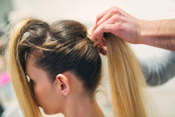 Fototapeta premium Young woman with blonde hair made by hair stylist in beauty salon