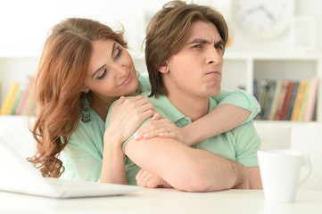 Beautiful young couple with a laptop
