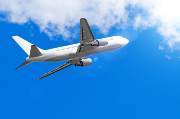 Fototapeta na wymiar White plane is climb up the height of cloud sun and glare