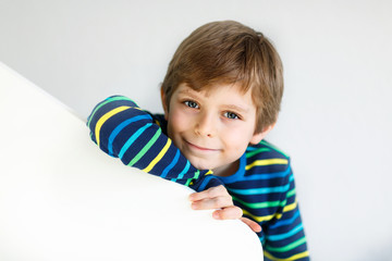 Portrait of little cute school kid boy in colorful clothes