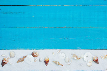 Blank wood beach sign with seashell and sand border