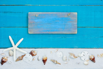 Blank teal blue beach sign with seashell and sand border