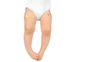 Baby legs with patches. Vaccination concept
