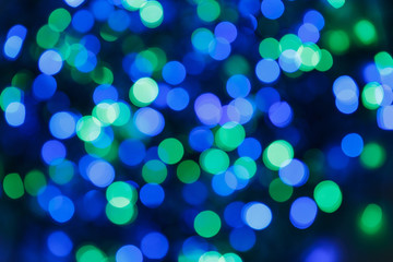 Blurred lights blue background. Glittering christmas effect. Abstract colorful pattern. Shimmering blur spots. Festive design.