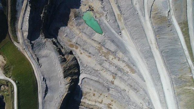 Flight over open cast mine, limestone quarry Peak District National Park. Aerial view of industrial landscape after mining. Industry and environment in England, Europe.