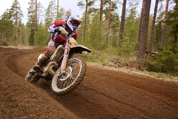 Foto auf Acrylglas Motocross driver accelerating the motorbike on the race track © Teemu Tretjakov