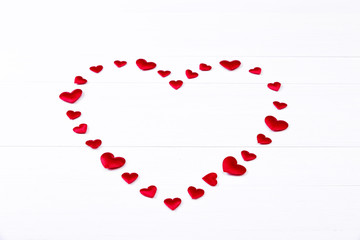 Red heart. Valentines day. Symbol of love. Romantic greeting background. On white wooden table.