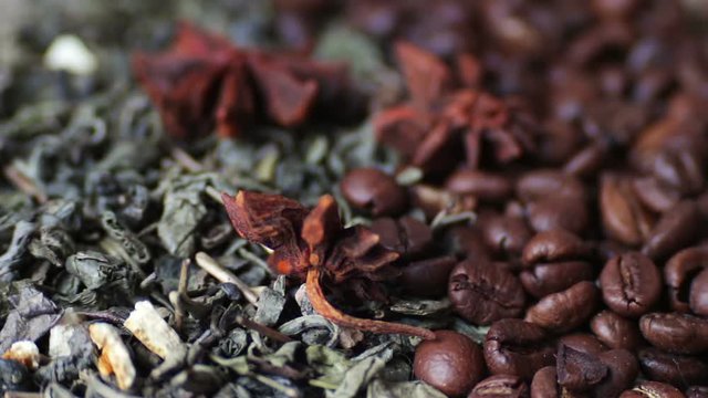 Green tea leaves and coffee beans Anise and sticks cinnamon close up rotation
