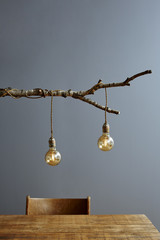 urban interior wooden table and branch lamp