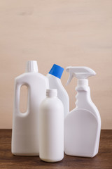 Mock-up plastic bottles. Cleaning products, washing wc cleaner. Mockup design for branding. Front view. Wooden rustic board.