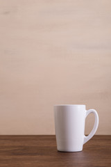 Mock-up mug. Mockup coffee or tea cup. Design concept for branding. Front view. Wooden rustic board.