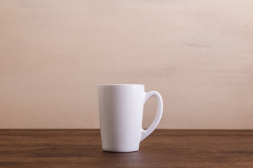 Mock-up mug. Mockup coffee or tea cup. Design concept for branding. Front view. Wooden rustic board.