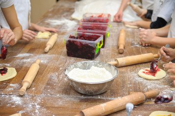 Young children make dough. Hands close up