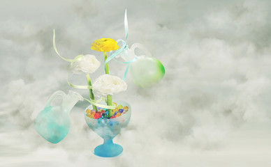 Flowers with a ribbons in a glass vase with multi-colored gel balls and two levitating glass jars on a light cloudy background