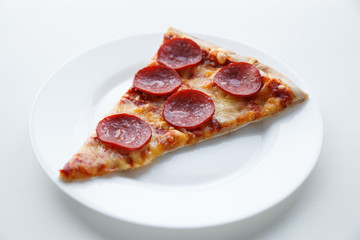 Pepperoni pizza. Hot homemade food. Slice of fresh italian classic salami pizza. Popular topping with cheese. Baked meal.