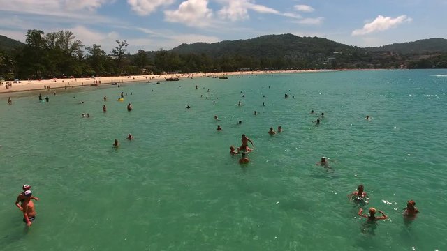 PHUKET, THAILAND - 20 JAN 2017: Crowd of people swimming in clear blue water