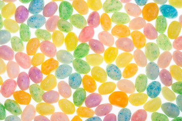 Easter jelly beans back-lit to glow in a colorful pattern
