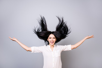 Portrait of charming smiling lady in white shirt with flying hair