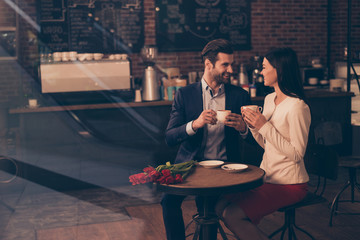 Happy romantic couple dating in a cafe drinking coffee