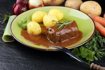 Tasty roulades beef on plate with potato, sauce, close up. beef roll, wrap of slice of beef