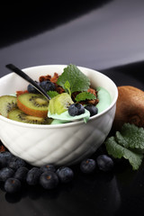 Smoothies bowl - matcha green tea breakfast superfoods topped wi