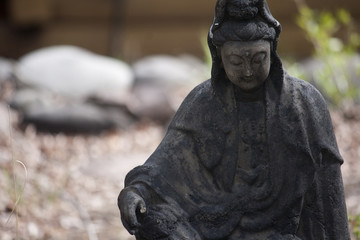 Fototapeta na wymiar Small Stone Buddha Statue