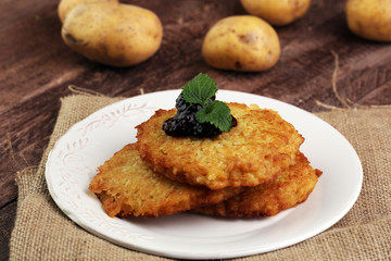 Potato pancake with cow berry sauce, selective focus