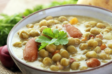 Light summer green pea cream soup in bowl