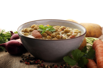 Light summer green pea cream soup in bowl