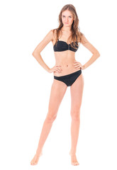 Naklejka premium Sexy young woman posing in a black bikini, isolated on white background