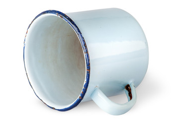 Old worn enameled mug lying
