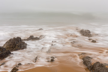 Landscape with fog in the Portio Beach. Liencres. Cantabria. Spain.