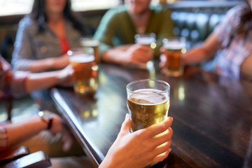 friends drinking beer at bar or pub