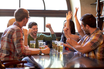 football fans or friends with beer at sport bar