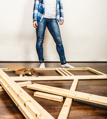 Woman assembling wood furniture. DIY.