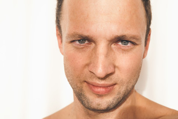 Caucasian man face over white wall