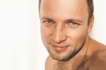 Young adult shirtless smiling man portrait